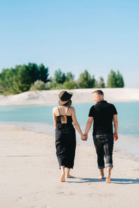 Rear view of women walking on beach