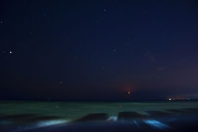 Scenic view of sea against sky at night