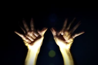 Close-up of human hand against black background