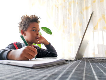 Portrait of cute girl sitting on table