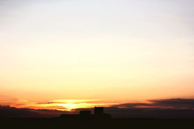 Silhouette of built structures at sunset