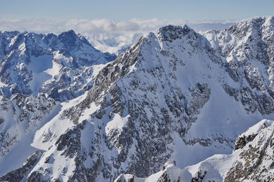 Scenic view of snow covered mountains against sky