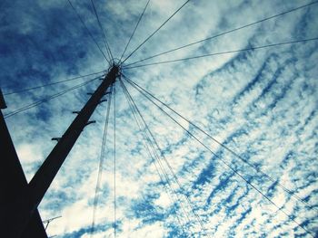 Low angle view of electricity pylon against sky