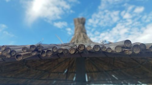 Low angle view of cross on roof against sky