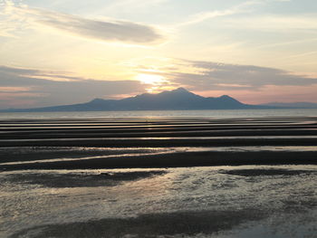 Scenic view of beach against sky during sunset