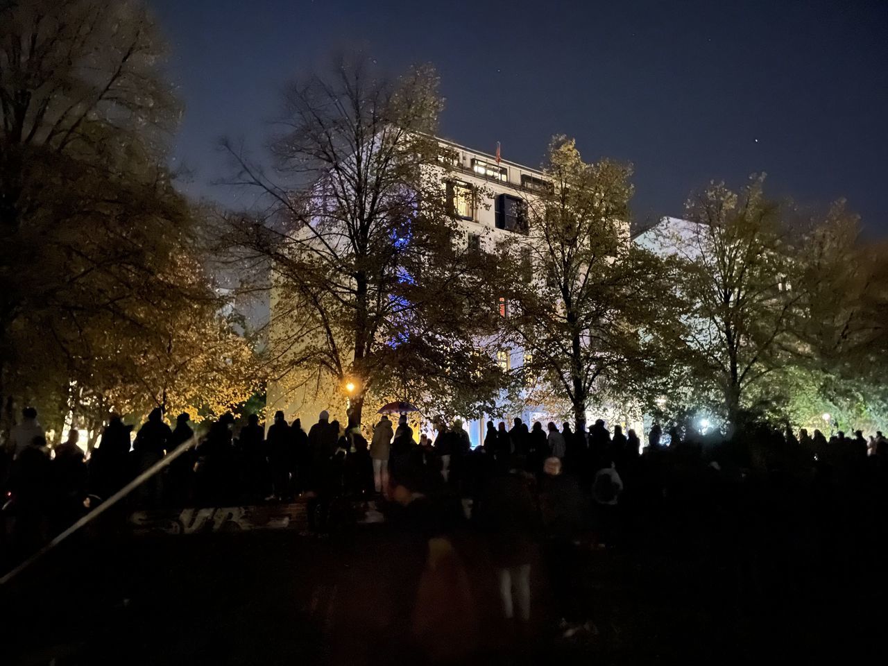 GROUP OF PEOPLE IN FRONT OF BUILDINGS