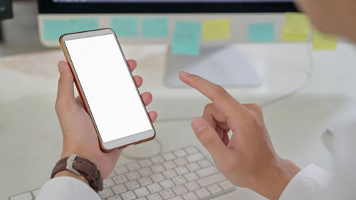 Midsection of person using mobile phone