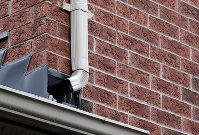 Low angle view of pipe on building wall