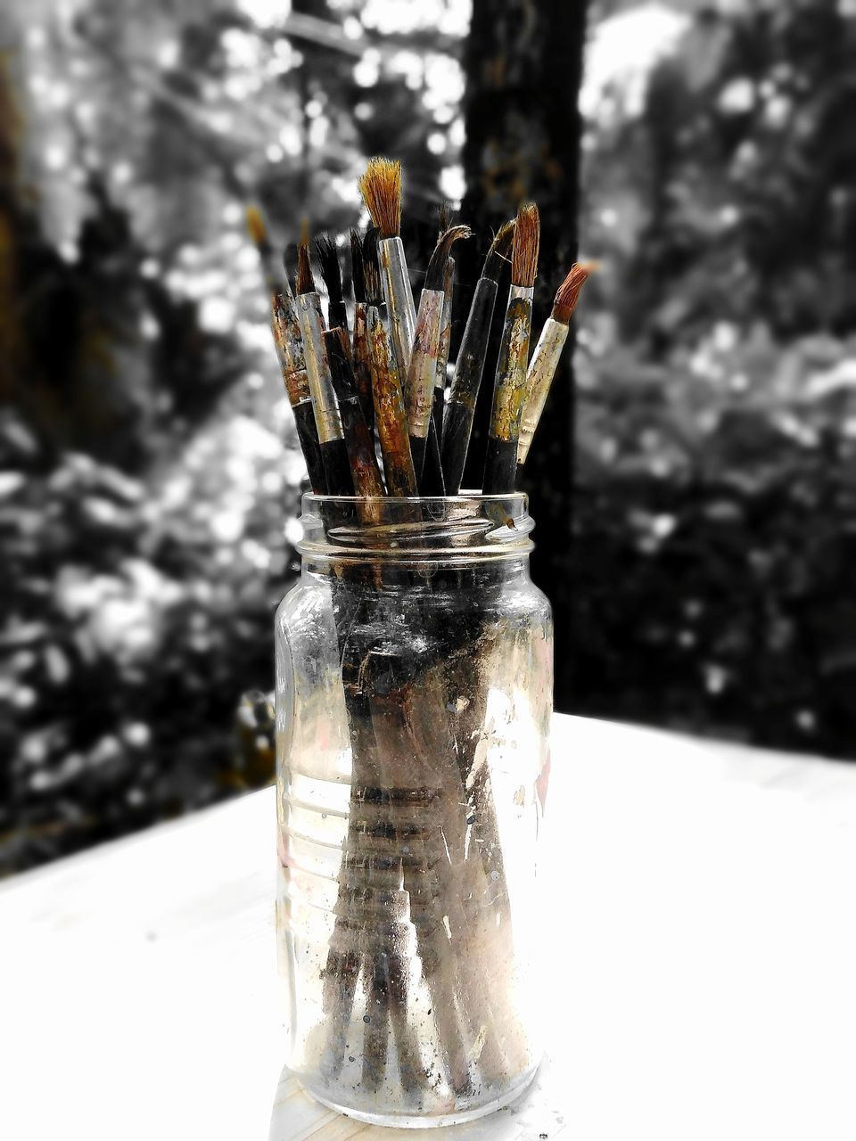 CLOSE-UP OF PAINTBRUSHES IN JAR