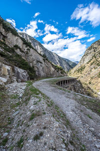 Scenic view of river by mountains against sky