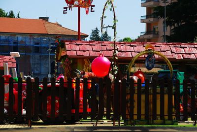 Multi colored balloons against buildings in city