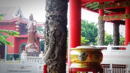 Statue outside temple against building