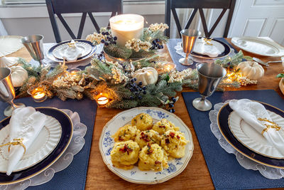 Mashed potatoes with bacon, chaddar, cheese, sour cream and chives on a holiday table at christmas.