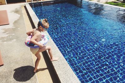 High angle view of girl walking by pool