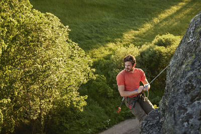 High angle view of man rock climbing