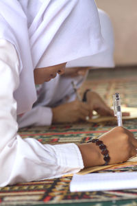 Cropped image of girls studying at home