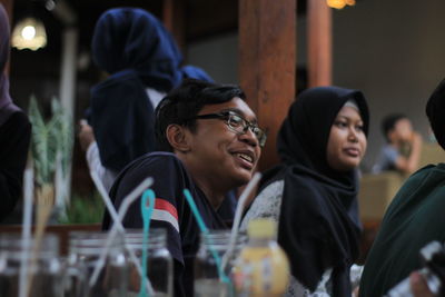 Side view of a young couple looking away