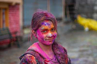 Young girl celebrating holi the festival of colors and joy