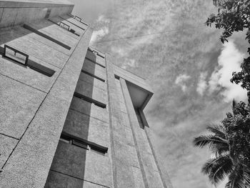 Low angle view of buildings against cloudy sky