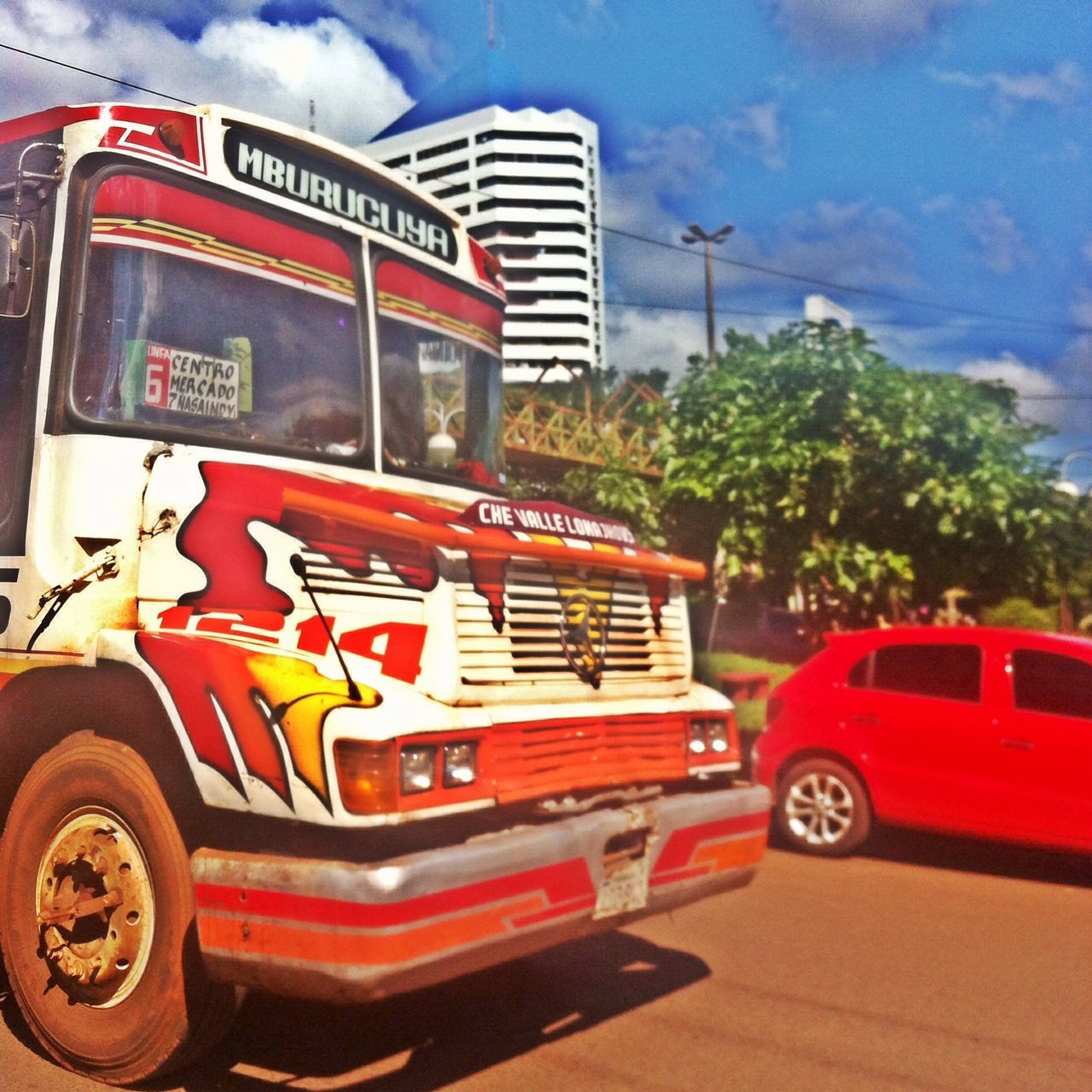 car, land vehicle, transportation, mode of transport, road, street, sky, travel, tree, red, stationary, cloud - sky, on the move, vehicle, outdoors, day, no people, cloud, parking, parking lot