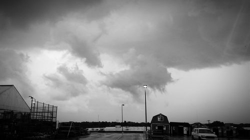 Street light against cloudy sky