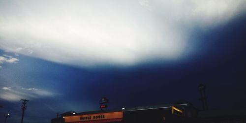 Low angle view of illuminated building against sky