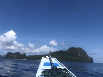 Sailboat in sea against sky