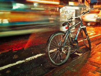 Bicycle parked on road at night