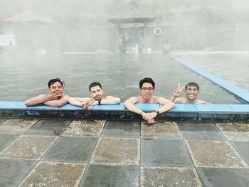 Portrait of people enjoying in swimming pool