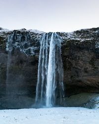 Scenic view of waterfall against clear sky