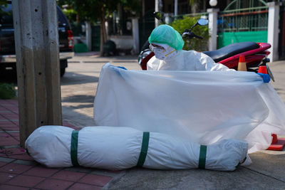 Rear view of man sitting on footpath