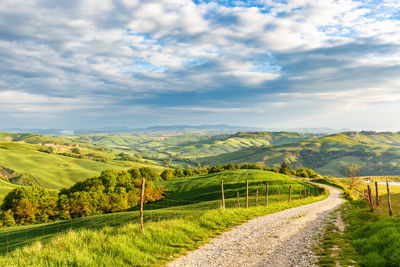 Dirt road into the valley in a rural italian landscape