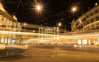 Illuminated city against sky at night