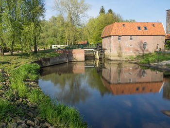 Scenic view of lake by building against sky