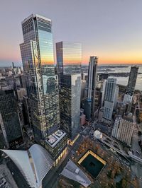 High angle view of modern buildings against sky during sunset