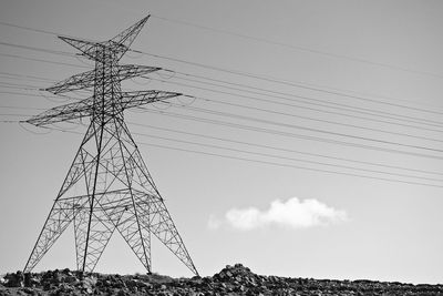 Low angle view of electricity pylon against sky