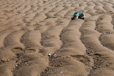 High angle view of footprints on sand at beach