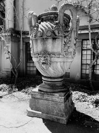 Old statue against abandoned wall