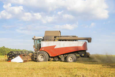 Tractor on field against sky