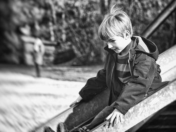 Boy sliding down slide at playground