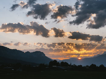 Scenic view of silhouette mountains against sky during sunset