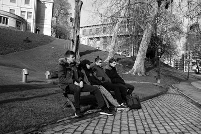 People sitting on footpath in park