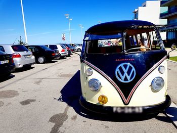 Cars on street against clear blue sky