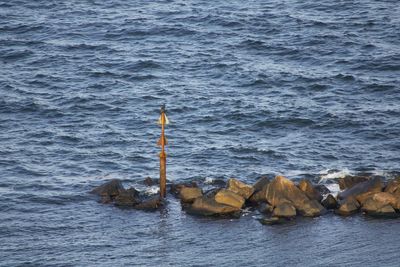 Rocks with navigation marks in sea