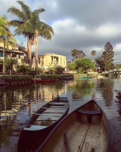 Boats in river with buildings in background