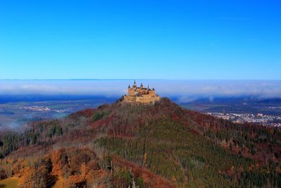 Panoramic view of landscape against blue sky