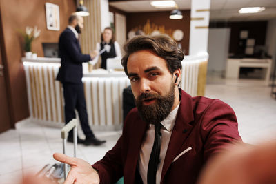 Portrait of young man using mobile phone