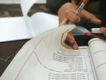 Close-up of hand holding book