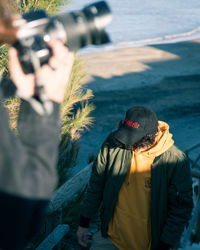 Rear view of man photographing sea