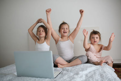 Girls funny crazy kids with laptop, concept of childhood and gadgets, life style, toning 